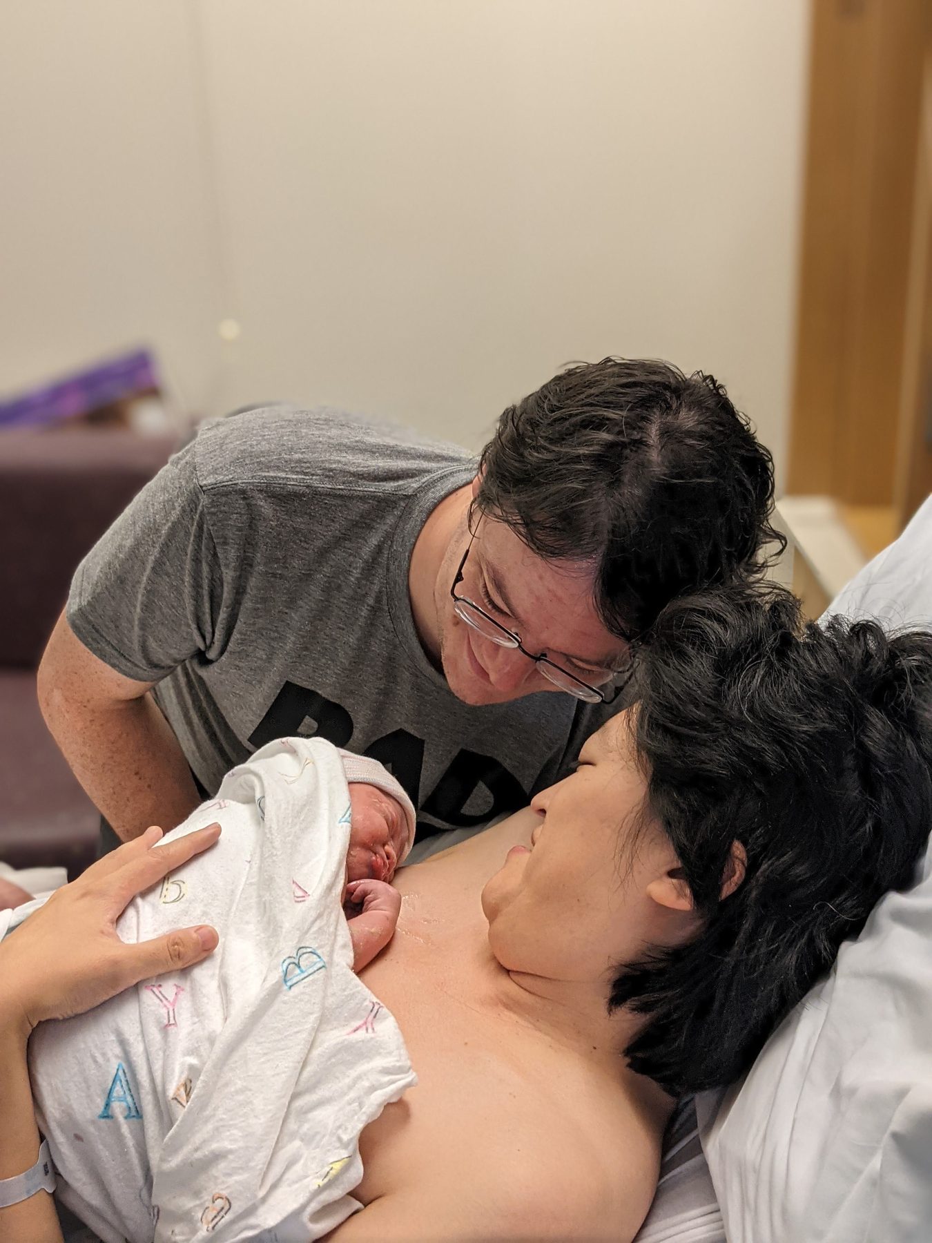 Leo as a newborn, held by his parents